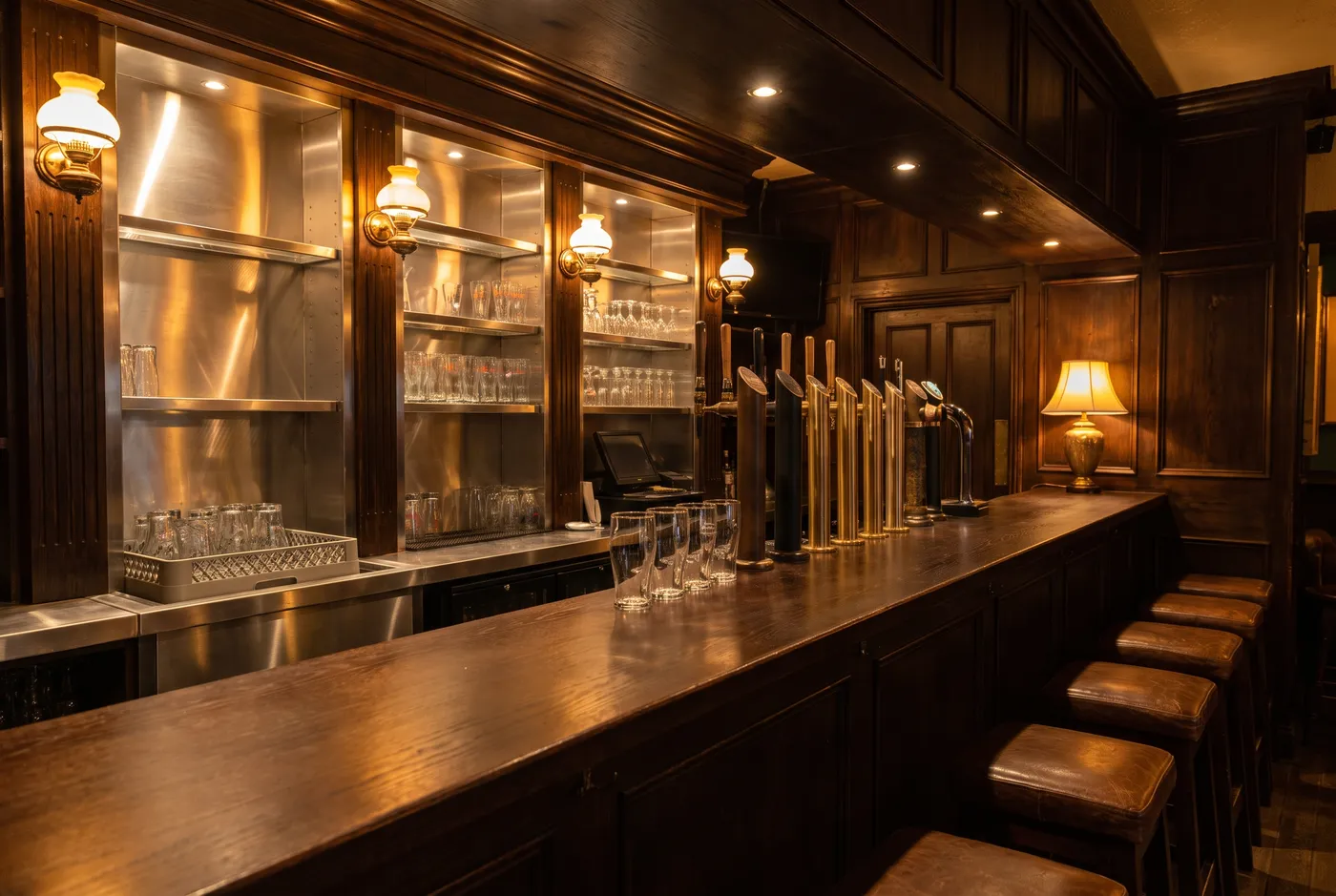 Irish pub bar with beer taps and a stainless steel back bar
